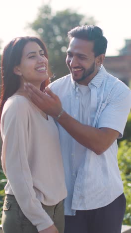 Vertical-Video-Of-Loving-Muslim-Couple-On-Date-Walking-Through-City-Park-Together